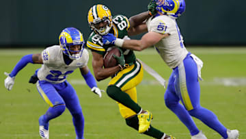 Green Bay Packers wide receiver Marquez Valdes-Scantling (83) runs for a first down on reception against Los Angeles Rams cornerback Troy Hill (22) and inside linebacker Troy Reeder (51) during their NFL divisional playoff game Saturday, January 16, 2021, at Lambeau Field in Green Bay, Wis.