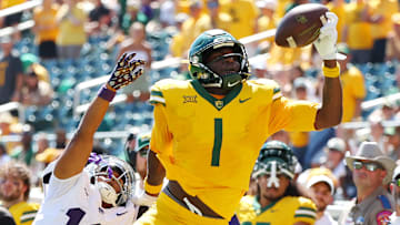 Tight end Michael Trigg #1 of the Baylor Bears makes a one handed catch in the fourth quarter against safety Wesley Fair #18 of the Kansas State Wildcats at McLane Stadium on October 04, 2025 in Waco, Texas.