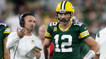 Green Bay Packers head coach Matt LaFleur talks with quarterback Aaron Rodgers in between quarters against the Chicago Bears during their game.