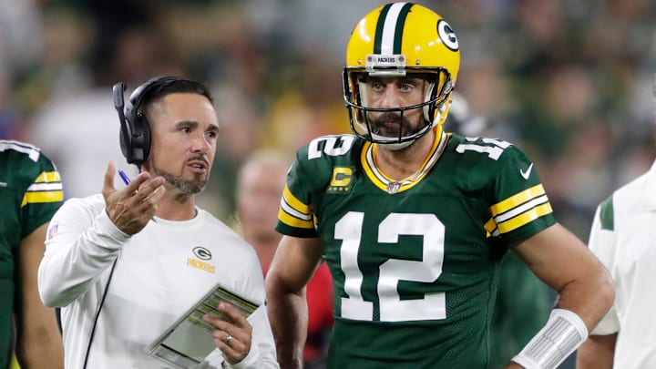 Green Bay Packers head coach Matt LaFleur talks with former quarterback Aaron Rodgers (12) in between quarters against the Chicago Bears during their game on Sep 18, 2022, in Green Bay, Wisconsin.
