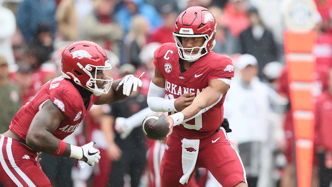 Arkansas Razorbacks quarterback Taylen Green (10) hands off to running back Mike Washington Jr (4) during the first quarter against the Auburn Tigers at Donald W. Reynolds Razorback Stadium.