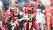 Arkansas Razorbacks quarterback Taylen Green (10) hands off to running back Mike Washington Jr (4) during the first quarter against the Auburn Tigers at Donald W. Reynolds Razorback Stadium.