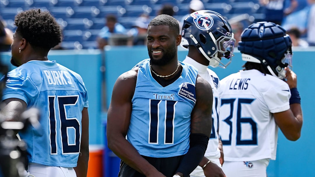 Tennessee Titans wide receiver Van Jefferson (11) puts his gloves on before stretching during “Back Together Weekend” training camp practice at Nissan Stadium Saturday, July 26, 2025, in Nashville, Tenn.