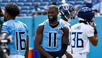 Tennessee Titans wide receiver Van Jefferson (11) puts his gloves on before stretching during “Back Together Weekend” training camp practice at Nissan Stadium Saturday, July 26, 2025, in Nashville, Tenn.