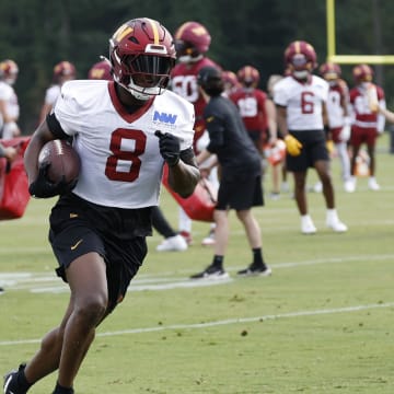 Jul 25, 2024; Ashburn, VA, USA; Washington Commanders running back Brian Robinson Jr. (8) carries a ball during drills on day two of Commanders training camp at OrthoVirginia Training Center at Commanders Park. Mandatory Credit: Geoff Burke-USA TODAY Sports