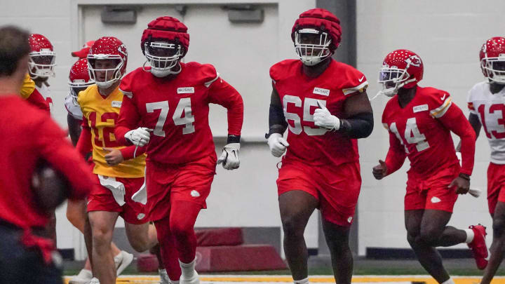 Jul 24, 2023; St. Joseph, MO, USA; Kansas City Chiefs offensive tackle Jawaan Taylor (74) and guard Trey Smith (65) and wide receiver Cornell Powell (14) run drills in the indoor practice facility during training camp at Missouri Western State University. Mandatory Credit: Denny Medley-USA TODAY Sports