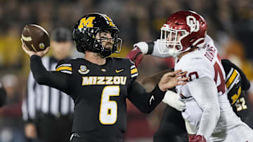 Nov 9, 2024; Columbia, Missouri, USA; Missouri Tigers quarterback Drew Pyne (6) throws a pass against Oklahoma Sooners defensive lineman Ethan Downs (40) during the second half at Faurot Field at Memorial Stadium. Mandatory Credit: Jay Biggerstaff-Imagn Images