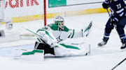 May 15, 2025; Winnipeg, Manitoba, CAN; Dallas Stars goalie Jake Oettinger (29) makes a save as Winnipeg Jets forward Brandon Tanev (73) looks for a rebound during the third period in game five of the second round of the 2025 Stanley Cup Playoffs at Canada Life Centre. Mandatory Credit: Terrence Lee-Imagn Images