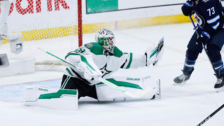 May 15, 2025; Winnipeg, Manitoba, CAN; Dallas Stars goalie Jake Oettinger (29) makes a save as Winnipeg Jets forward Brandon Tanev (73) looks for a rebound during the third period in game five of the second round of the 2025 Stanley Cup Playoffs at Canada Life Centre. Mandatory Credit: Terrence Lee-Imagn Images