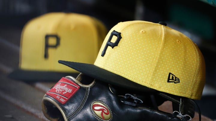 Sep 16, 2023; Pittsburgh, Pennsylvania, USA;  Pittsburgh Pirates hats and gloves in the dugout against the New York Yankees during the sixth inning at PNC Park. Mandatory Credit: Charles LeClaire-USA TODAY Sports