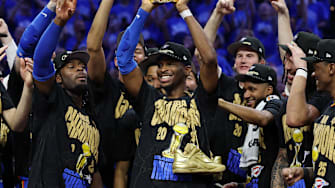 Shai Gilgeous-Alexander holds up the NBA Finals MVP trophy after the Thunder won the NBA championship.