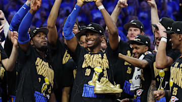 Shai Gilgeous-Alexander holds up the NBA Finals MVP trophy after the Thunder won the NBA championship.