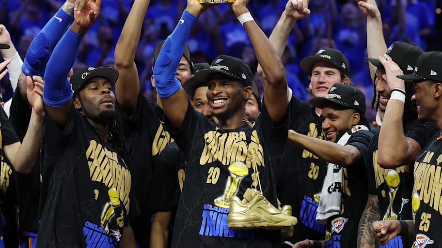 Shai Gilgeous-Alexander holds up the NBA Finals MVP trophy after the Thunder won the NBA championship. | Matthew Stockman/Getty Images