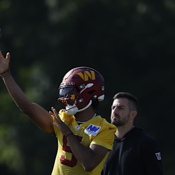 Washington Commanders quarterback Jayden Daniels passes a ball during practice on day two of training camp.