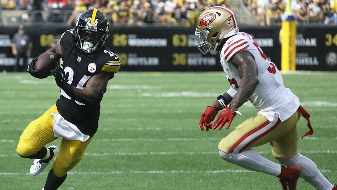 Sep 10, 2023; Pittsburgh, Pennsylvania, USA;  Pittsburgh Steelers running back Anthony McFarland Jr. (26) runs the ball against San Francisco 49ers linebacker Dre Greenlaw (57) during the third quarter at Acrisure Stadium. San Francisco won 30-7. Mandatory Credit: Charles LeClaire-Imagn Images