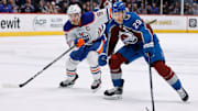 Feb 19, 2023; Denver, Colorado, USA; Colorado Avalanche center Nathan MacKinnon (29) controls the puck ahead of Edmonton Oilers center Connor McDavid (97) in overtime at Ball Arena. Mandatory Credit: Isaiah J. Downing-Imagn Images