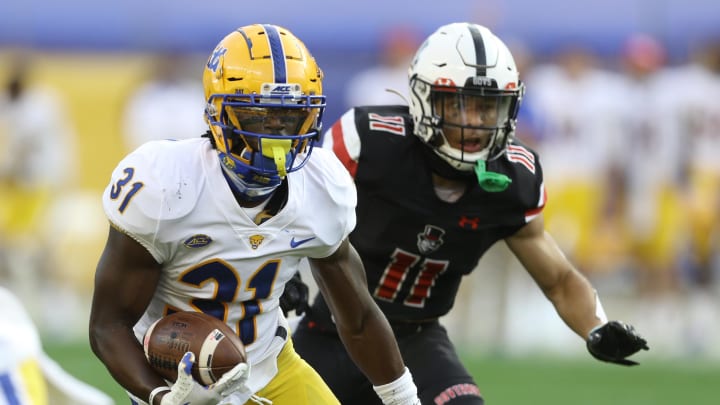 Sep 12, 2020; Pittsburgh, Pennsylvania, USA;  Pittsburgh Panthers defensive back Erick Hallett (31) returns an interception against Austin Peay Governors wide receiver DeAngelo Wilson (11) during the third quarter at Heinz Field. Pittsburgh won 55-0. Mandatory Credit: Charles LeClaire-USA TODAY Sports