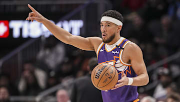 Jan 14, 2025; Atlanta, Georgia, USA; Phoenix Suns guard Devin Booker (1) directs his teammates against the Atlanta Hawks during the first half at State Farm Arena. Mandatory Credit: Dale Zanine-Imagn Images