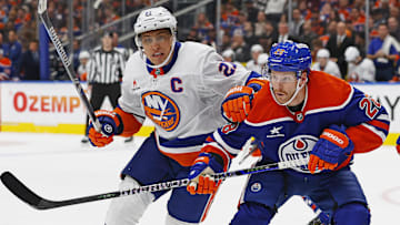 Nov 12, 2024; Edmonton, Alberta, CAN; Edmonton Oilers forward Connor Brown (28) and New York Islanders forward Anders Lee (27) battle for position  during the second period at Rogers Place. Mandatory Credit: Perry Nelson-Imagn Images