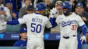 Apr 1, 2025; Los Angeles, California, USA;  Los Angeles Dodgers shortstop Mookie Betts (50) is congratulated by left fielder Teoscar Hernandez (37) after hitting a two run home run in the sixth inning against the Atlanta Braves at Dodger Stadium. Mandatory Credit: Jayne Kamin-Oncea-Imagn Images