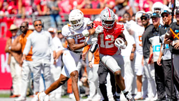 Ohio State Buckeyes running back CJ Donaldson (12) runs the ball against Texas Longhorns defensive back Malik Muhammad (5) in the second half at Ohio Stadium on Saturday, Aug. 30, 2025 in Columbus, Ohio.