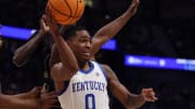 Kentucky Wildcats guard Rob Dillingham (0) looks to pass the ball under pressure during their quarterfinal game against Texas A&M of the SEC Men's Basketball Tournament at Bridgestone Arena in Nashville, Tenn., Friday, March 15, 2024.