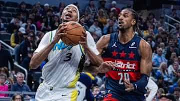 Nov 24, 2024; Indianapolis, Indiana, USA; Indiana Pacers center Moses Brown (3) shoots the ball while Washington Wizards forward Alexandre Sarr (20) defends in the first quarter at Gainbridge Fieldhouse. Mandatory Credit: Trevor Ruszkowski-Imagn Images