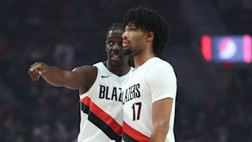 Portland Trail Blazers guards Jrue Holiday and Shaedon Sharpe talk during a break in the action of the first half at Moda Center on October 10.