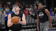 Nov 15, 2025; Charlotte, North Carolina, USA; Oklahoma City Thunder forward Brooks Barnhizer (23) shoots as guard Chris Youngblood (3) watches during pregame warm ups against the Charlotte Hornets at Spectrum Center. Mandatory Credit: Jim Dedmon-Imagn Images