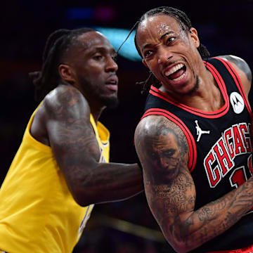 Jan 25, 2024; Los Angeles, California, USA; Chicago Bulls forward DeMar DeRozan (11) moves the ball ahead of Los Angeles Lakers forward Taurean Prince (12) during the second half at Crypto.com Arena. Mandatory Credit: Gary A. Vasquez-Imagn Images