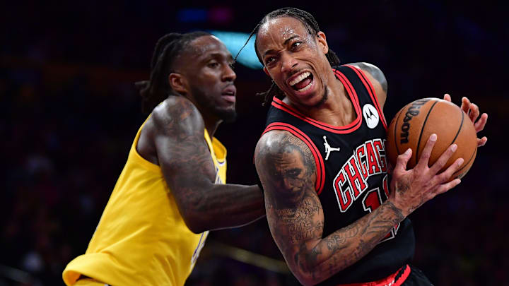 Jan 25, 2024; Los Angeles, California, USA; Chicago Bulls forward DeMar DeRozan (11) moves the ball ahead of Los Angeles Lakers forward Taurean Prince (12) during the second half at Crypto.com Arena. Mandatory Credit: Gary A. Vasquez-Imagn Images