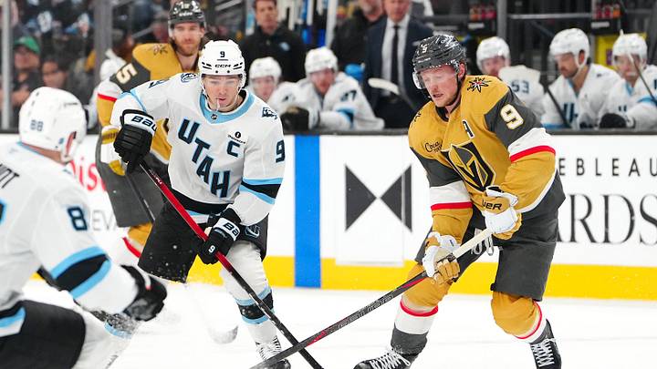 Mar 19, 2026; Las Vegas, Nevada, USA; Utah Mammoth right wing Clayton Keller (9) keeps the puck away from Vegas Golden Knights center Jack Eichel (9) during the second period at T-Mobile Arena. Mandatory Credit: Stephen R. Sylvanie-Imagn Images
