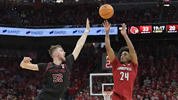 Mar 8, 2025; Louisville, Kentucky, USA;  Louisville Cardinals guard Chucky Hepburn (24) shoots against Stanford Cardinal forward Aidan Cammann (52) during the second half at KFC Yum! Center. Louisville defeated Stanford 68-48. Mandatory Credit: Jamie Rhodes-Imagn Images