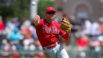 Mar 26, 2023; Sarasota, Florida, USA;  Philadelphia Phillies shortstop Scott Kingery (4) throws to first against the Baltimore Orioles in the fourth inning during spring training at Ed Smith Stadium.