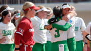 Oregon's Ariel Carlson (3) and Alyssa Daniell (10) hug following the NCAA Norman Regional tournament