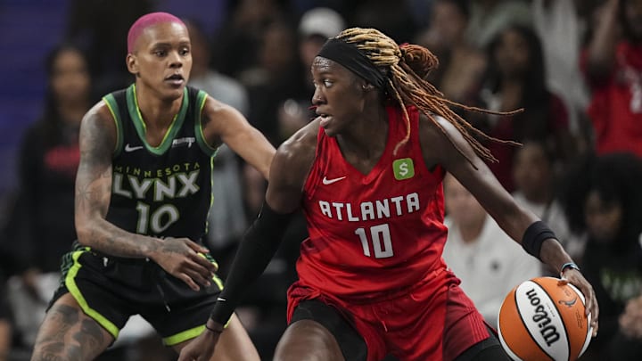 Aug 21, 2025; College Park, Georgia, USA; Atlanta Dream guard Rhyne Howard (10) controls the ball against Minnesota Lynx guard Courtney Williams (10) during the second half at Gateway Center Arena at College Park. Mandatory Credit: Dale Zanine-Imagn Images