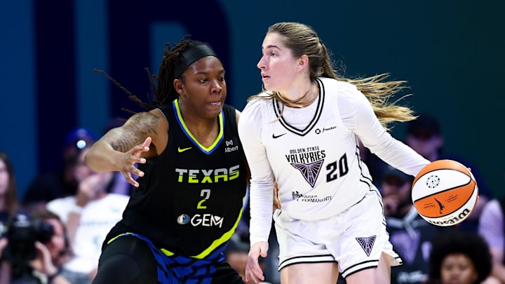 Golden State Valkyries guard Kate Martin controls the ball as Dallas Wings forward Myisha Hines-Allen defends