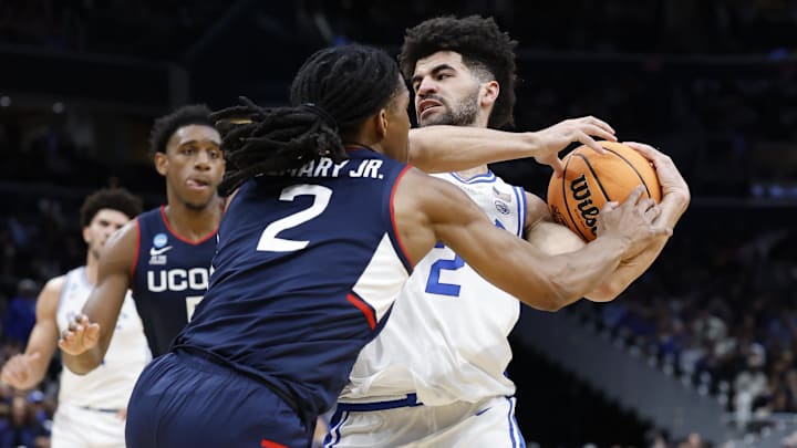 Mar 29, 2026; Washington, DC, USA; Duke Blue Devils guard Cayden Boozer (2) goes to the basket against UConn Huskies guard Silas Demary Jr. (2) in the first half during an Elite Eight game of the East Regional of the men's 2026 NCAA Tournament at Capital One Arena. Mandatory Credit: Amber Searls-Imagn Images