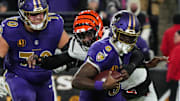 Bengals Joseph Ossai (58) helps take down Ravens Lamar Jackson (8) for the Bengals to take the ball during their game against the Ravens at M&T Bank Stadium on Thanksgiving Thursday November 27, 2025.