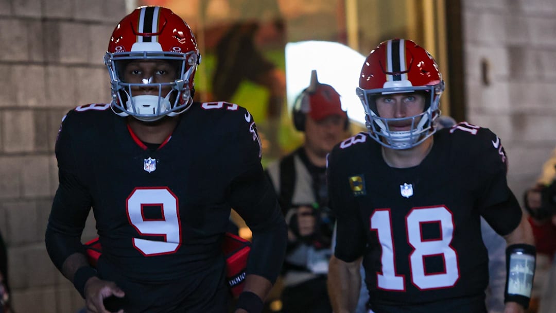 Dec 22, 2024; Atlanta, Georgia, USA; Atlanta Falcons quarterback Michael Penix Jr. (9) and quarterback Kirk Cousins (18) run on the field before a game against the New York Giants at Mercedes-Benz Stadium. Mandatory Credit: Brett Davis-Imagn Images
