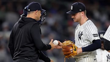 Jun 16, 2025; Bronx, New York, USA; New York Yankees starting pitcher Clarke Schmidt (36) is taken out of the game by manager Aaron Boone (17) during the eighth inning against the Los Angeles Angels at Yankee Stadium. Mandatory Credit: Brad Penner-Imagn Images