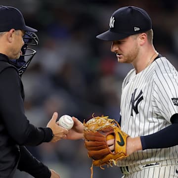 Jun 16, 2025; Bronx, New York, USA; New York Yankees starting pitcher Clarke Schmidt (36) is taken out of the game by manager Aaron Boone (17) during the eighth inning against the Los Angeles Angels at Yankee Stadium. Mandatory Credit: Brad Penner-Imagn Images