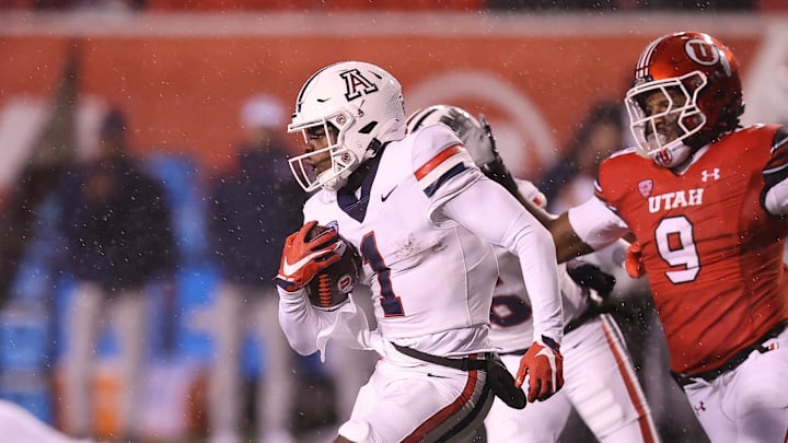 Nov 5, 2022; Salt Lake City, Utah, USA; Arizona Wildcats wide receiver Anthony Simpson (1) returns a kickoff against Utah Utes running back Tavion Thomas (9) in the third quarter at Rice-Eccles Stadium. Mandatory Credit: Rob Gray-Imagn Images