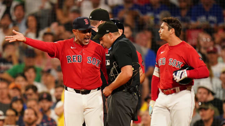 Aug 26, 2024; Boston, Massachusetts, USA; Boston Red Sox manager Alex Cora (13) talks with umpire Paul Clemons after a call as they take on the Toronto Blue Jays in the third inning at Fenway Park. Mandatory Credit: David Butler II-USA TODAY Sports