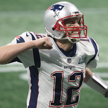 Feb 3, 2019; Atlanta, GA, USA; New England Patriots quarterback Tom Brady (12) celebrates after a Patriots touchdown  against the Los Angeles Rams during the fourth quarter of Super Bowl LIII at Mercedes-Benz Stadium.