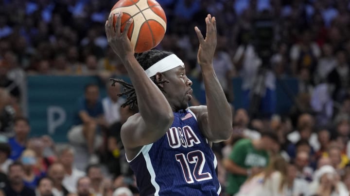 Jul 28, 2024; Villeneuve-d'Ascq, France; United States guard Jrue Holiday (12) passes in the first quarter against Serbia during the Paris 2024 Olympic Summer Games at Stade Pierre-Mauroy. Mandatory Credit: John David Mercer-USA TODAY Sports