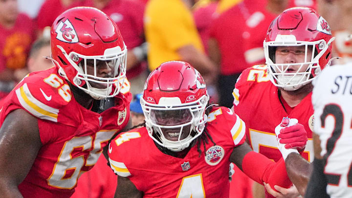 Sep 15, 2024; Kansas City, Missouri, USA; Kansas City Chiefs wide receiver Rashee Rice (4) is helped up by guard Trey Smith (65) against the Cincinnati Bengals after a penalty during the second half at GEHA Field at Arrowhead Stadium. Mandatory Credit: Denny Medley-Imagn Images