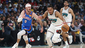Apr 24, 2025; Memphis, Tennessee, USA; Memphis Grizzlies guard Desmond Bane (22) dribbles as Oklahoma City Thunder guard Alex Caruso (9) defends during the second quarter during game three for the first round of the 2025 NBA Playoffs at FedExForum. Mandatory Credit: Petre Thomas-Imagn Images