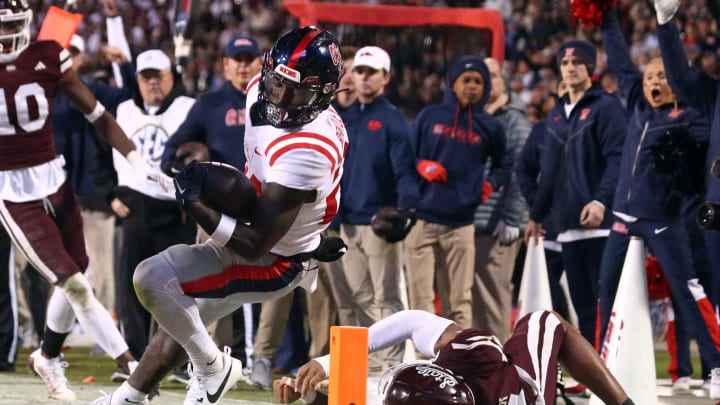 Nov 23, 2023; Starkville, Mississippi, USA; Mississippi Rebels running back Ulysses Bentley IV (24) runs the ball  as Mississippi State Bulldogs linebacker Nathaniel Watson (14) knocks him out at the one yard line during the second half at Davis Wade Stadium at Scott Field. Mandatory Credit: Petre Thomas-USA TODAY Sports