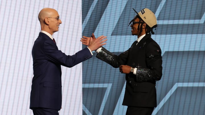 Rob Dillingham shakes hands with NBA commissioner Adam Silver.